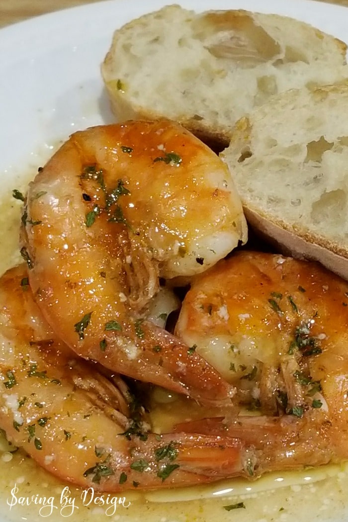 baked bbq shrimp on plate with bread